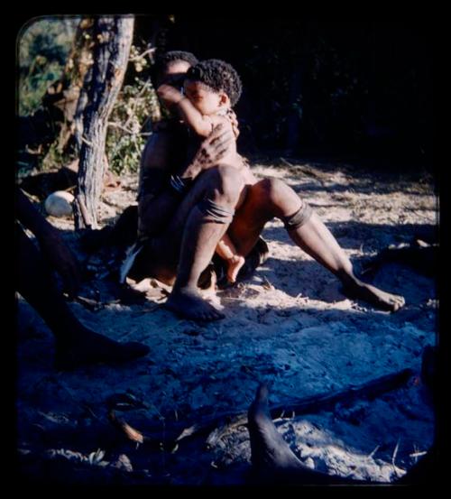 Children, Mothers nursing babies: Woman sitting and holding a child