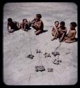 Toys: Group of boys sitting, with toy cars in the foreground