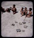 Toys: Group of boys sitting, with toy cars in the foreground