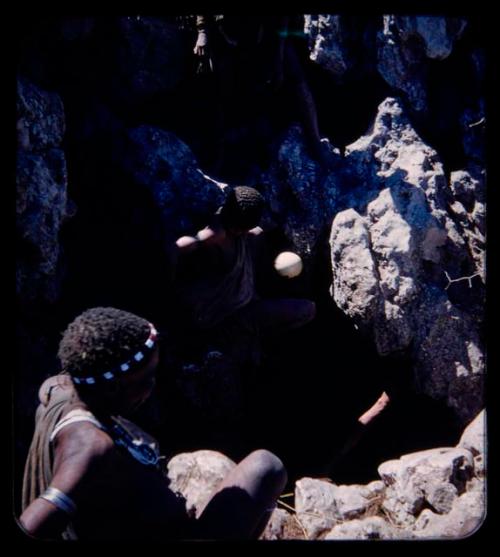 Waterhole: Men climbing into waterhole to get water