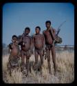 Portraits: Girl and three men (including ≠Toma) holding hunting equipment and standing in a row