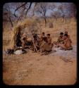 Skerm: Group of people sitting near a windbreak type of skerm