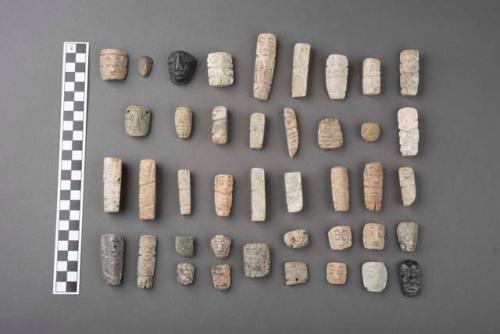 Ground stone effigies and pendants; incised; some perforated