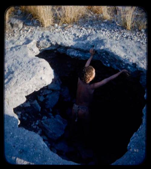 Waterhole: Boy standing in a dry waterhole on the way to Gautscha