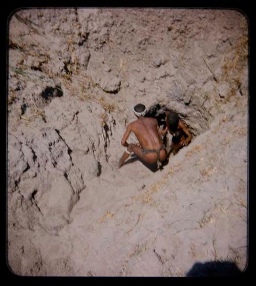 Waterhole: Two men at a waterhole