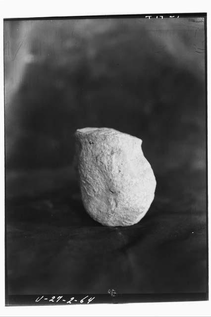 Limestone human figurine in sqatting position, head gone, from rubble of E-VII s