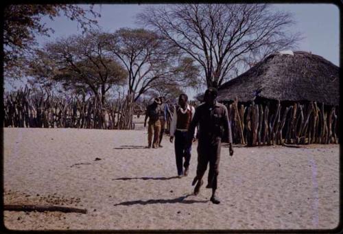 Men walking from a village