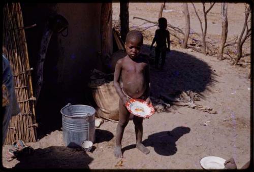 Boy holding a plate of King and Queen of England