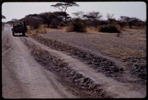 Expedition Jeep driving on a road, seen from behind