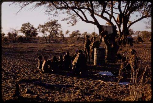 People sitting and standing in a kraal