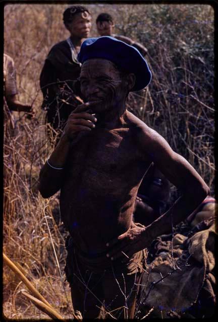 //Ao's father-in-law wearing a blue beret, standing