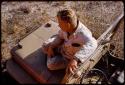 Theunis Berger sitting on hood of the expedition Jeep