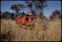 Expedition Red Dodge driving in golden grass