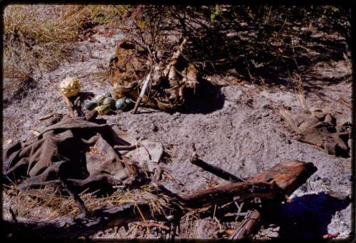 Piles of tsama melons, bows, arrows, and cloth on the ground