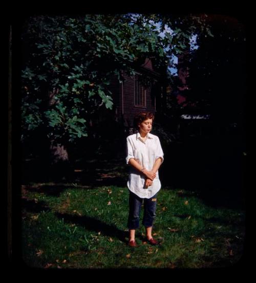 Elizabeth Marshall Thomas standing under a tree, with a house in the background