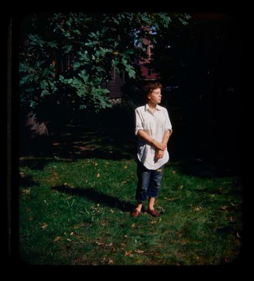 Elizabeth Marshall Thomas standing under a tree, with a house in the background