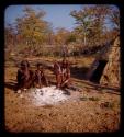 Kanakele and Capepe sitting with three children in front of a hut