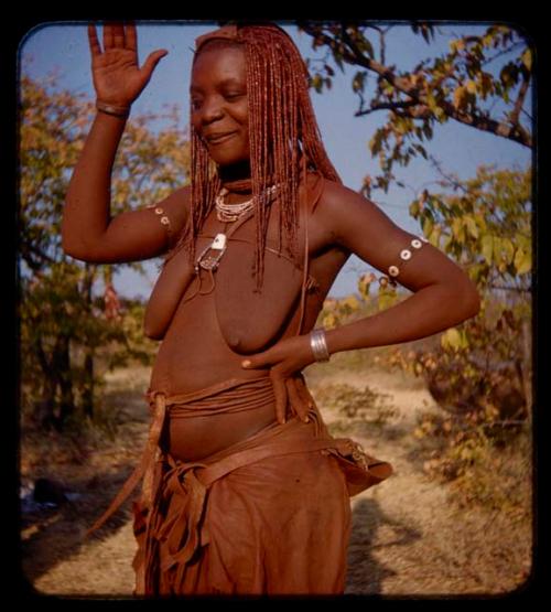 Woman standing with her hand raised, close-up