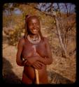 Woman wearing a necklace with two peanuts strung on it