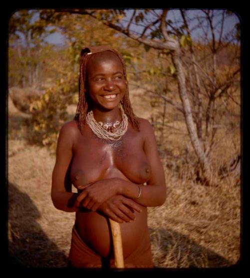 Woman wearing a necklace with two peanuts strung on it