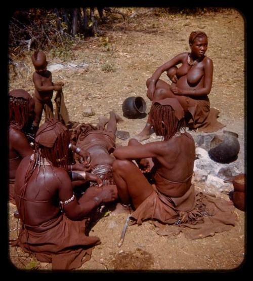 Group of women styling Catchucucere's (Meri Catinga's daughter) hair