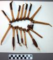 Set of 15 cutting tools made of an agouti tooth set in the femur of a howling mo