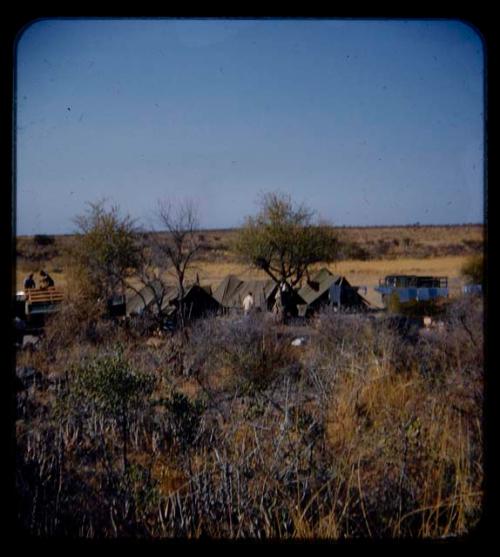 Expedition: View of expedition camp, with green tents and trucks