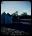 Expedition: Expedition members at the campsite, with two tents in the background