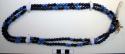 Necklace of black and blue beads; beads are commercially made.