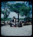 Expedition: Group of people and expedition members gathered at the campsite, with interpreters talking