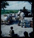 Expedition: Group of people and expedition members gathered at the campsite, with interpreters talking