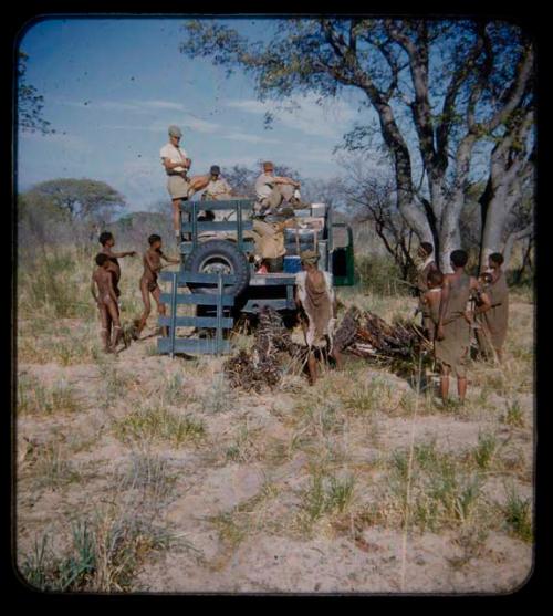 Expedition: Expedition members loading in a truck, with a group of people watching them nearby