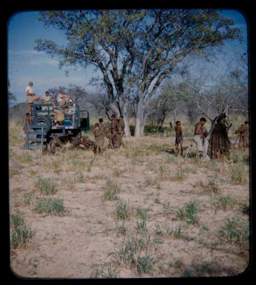 Expedition: Expedition members loading in a truck, with a group of people watching them nearby