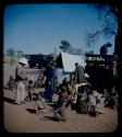 Expedition: Laurence Marshall, Lorna Marshall, Kernel Ledimo, and a group of people gathered near a truck, with a tent