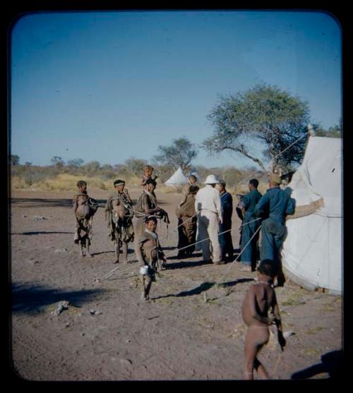 Expedition: Expedition members, including Laurence Marshall and Lorna Marshall, and a group of people standing near a tent