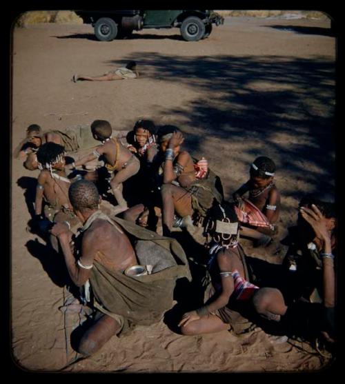 Expedition: Group of women and children wearing striped cloth, sitting