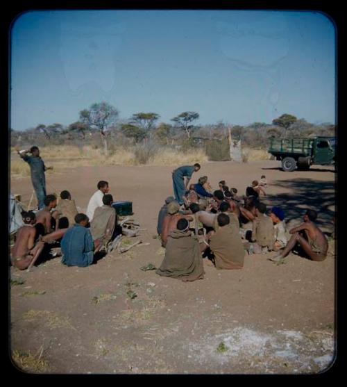 Expedition: Group of people sitting, with expedition members, including Lorna Marshall and Kernel Ledimo