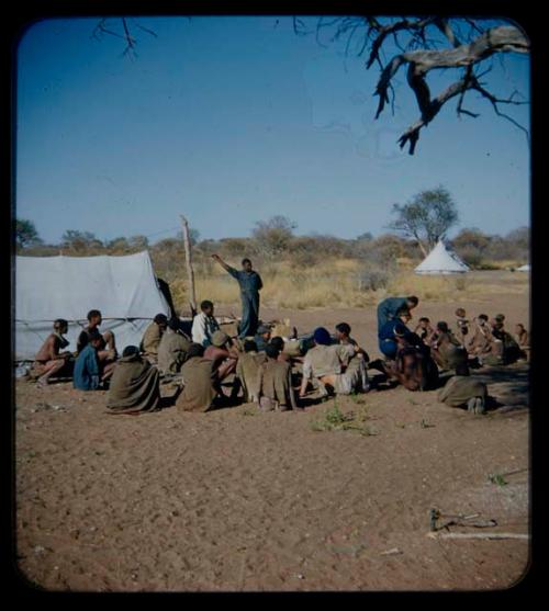 Expedition: Group of people sitting, with expedition members, including Lorna Marshall and Kernel Ledimo