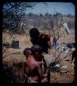 Expedition: Man showing a hat to two boys