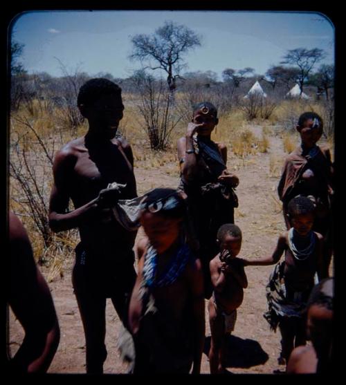 Expedition: Group of people standing, with tents in the background