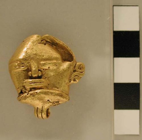 Gold bells, human faces. Cast trumbaga, Veraguas style. A.D. 900-1200 (exhibit n