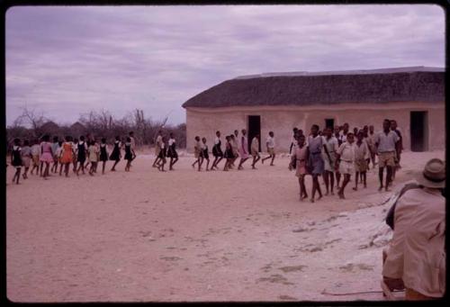 Students forming lines to enter a school