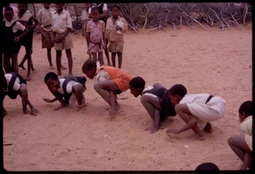 Girls imitating frogs at recess at a school