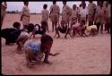 Girls imitating frogs at recess at a school