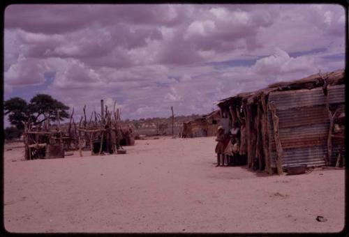 People standing next to a structure in Gemsbok Park, a game preserve on the Nossob River