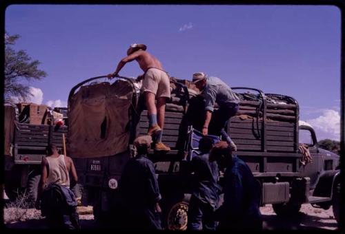 Expedition members unloading one of the trucks (GMC), view from behind