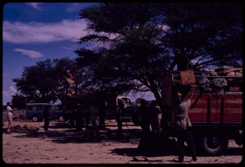 Expedition members unloading trucks, view from behind