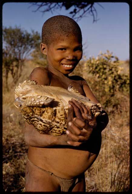 Boy holding a turtle