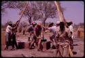 Group of people working on a bore hole for a water pump
