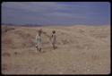 Lorna Marshall and O.P.M. Prozesky standing on rocky yellow grassland